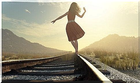 woman walking on a train track