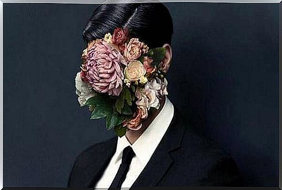 person with flowers covering his face