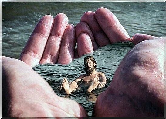 Man floating in water in hands