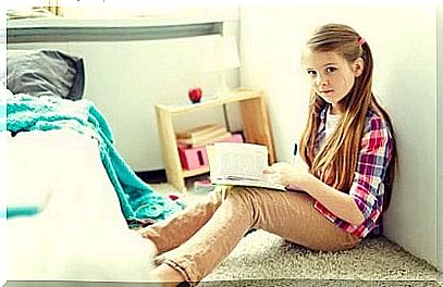 girl reading a book in her room.