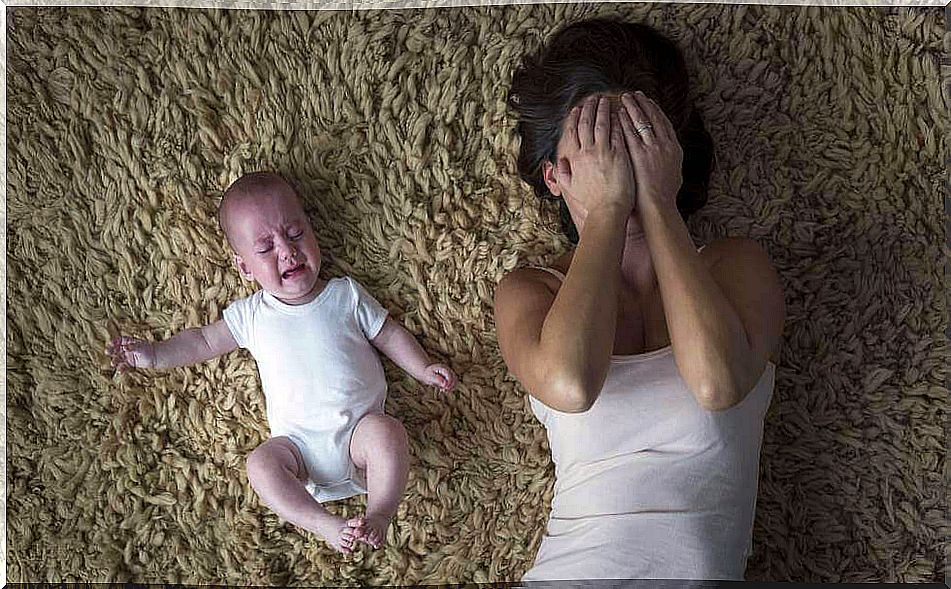 Desperate mother with crying baby