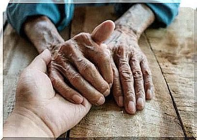 Adult taking an elderly person's hand